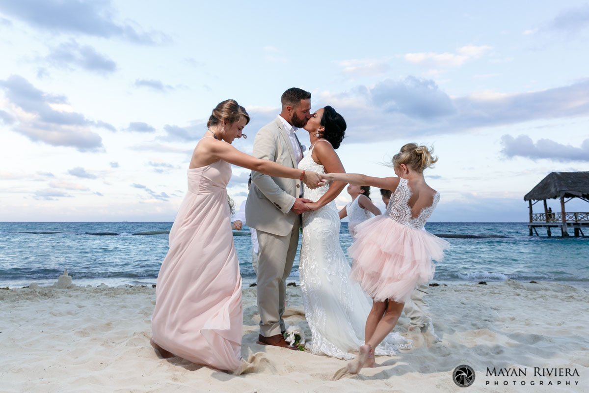 KidsRunningAroundEmbracingParents