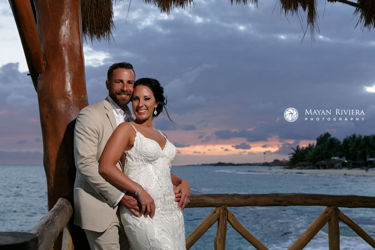 NewlywedsPoseOnPierAtSunset