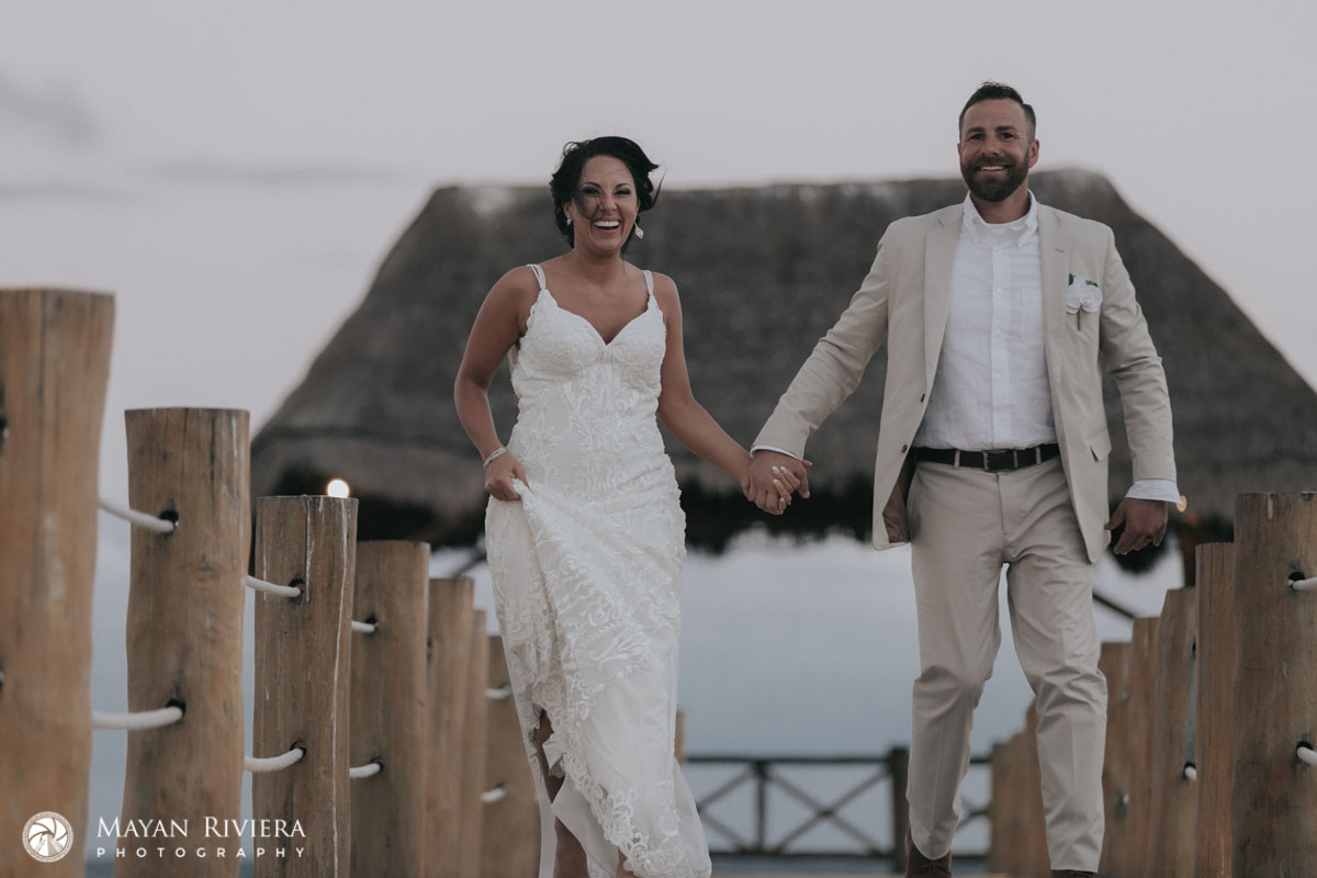 NewlywedsRunOnPierLaughing