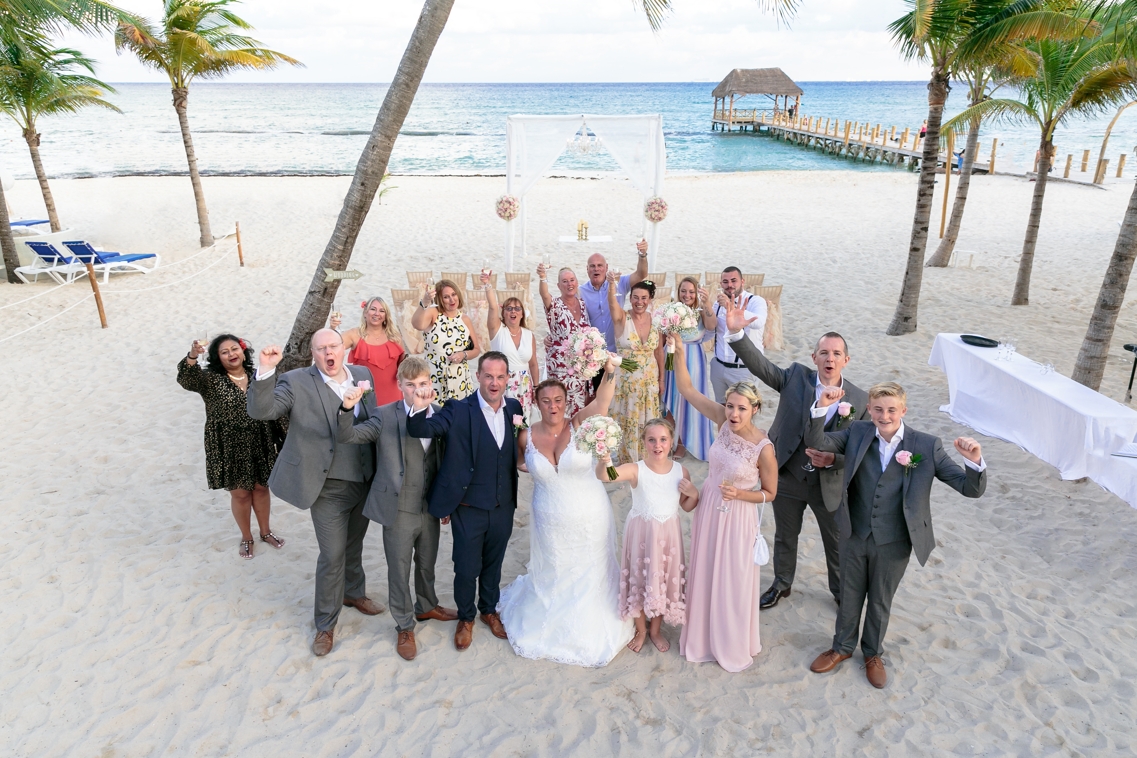 AzulBeachNewlywedsCheerWithGuestsInDroneShot