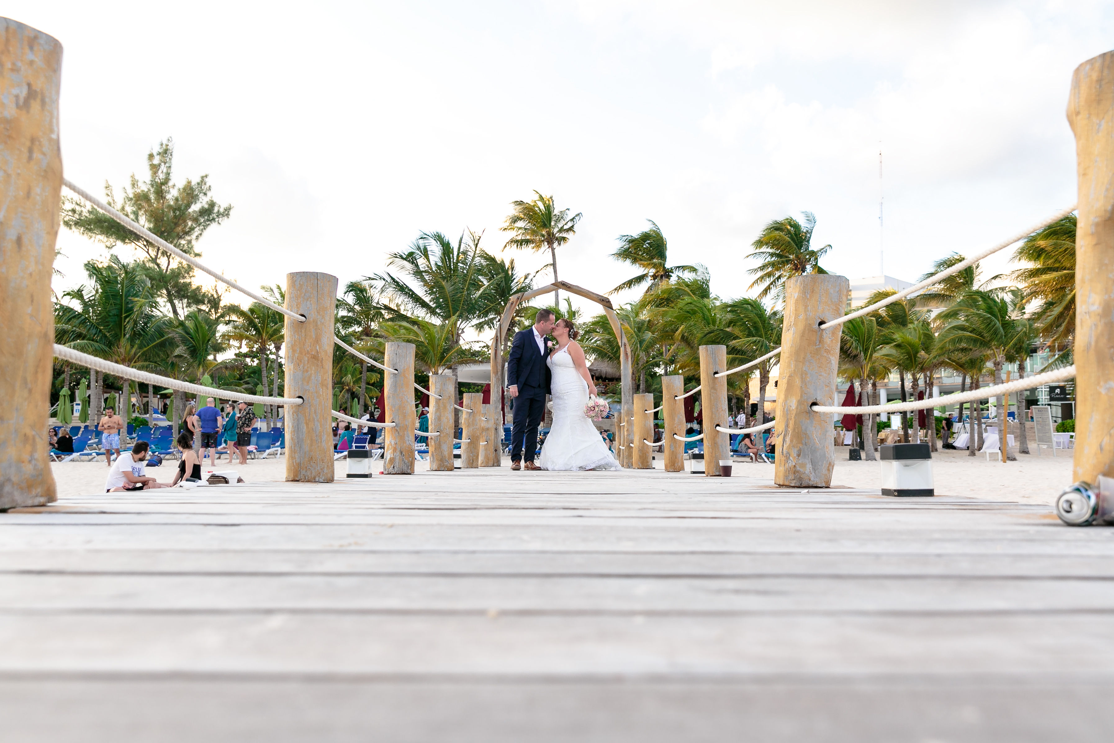 AzulBeachNewlywedsKissOnPier