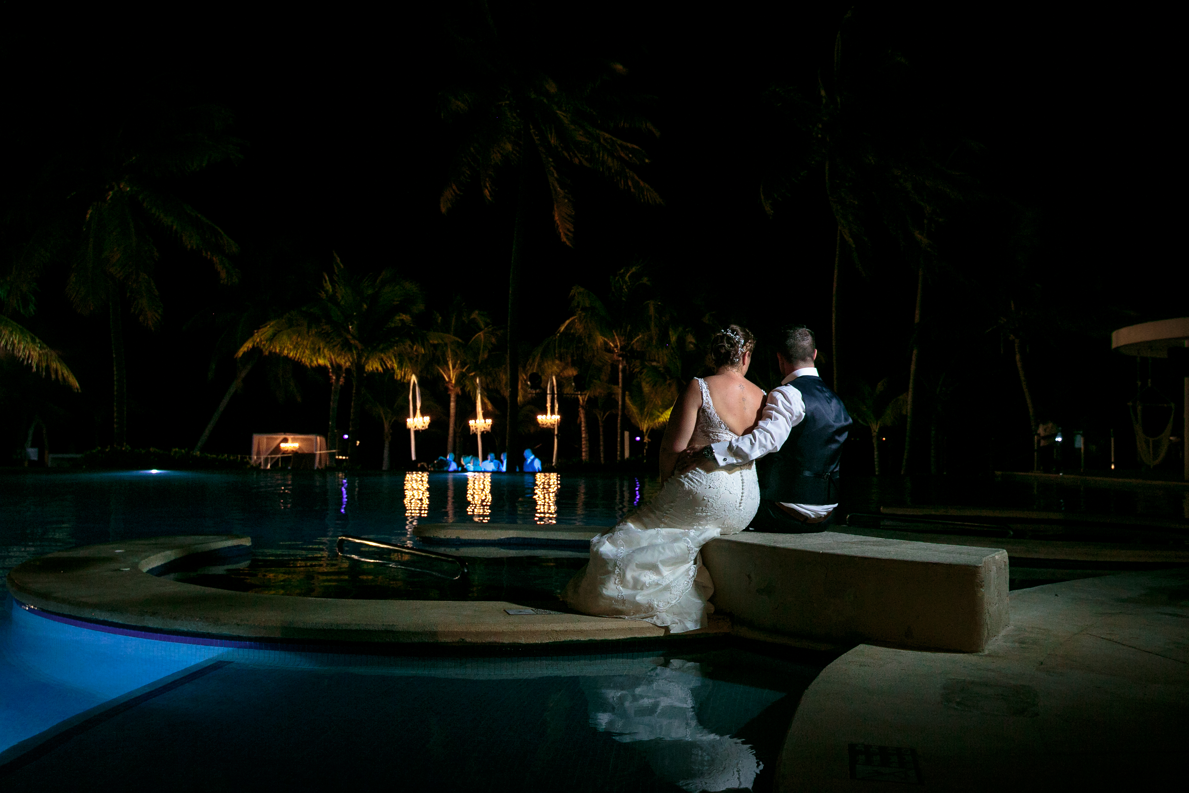 NewlywedsSitBesidePool