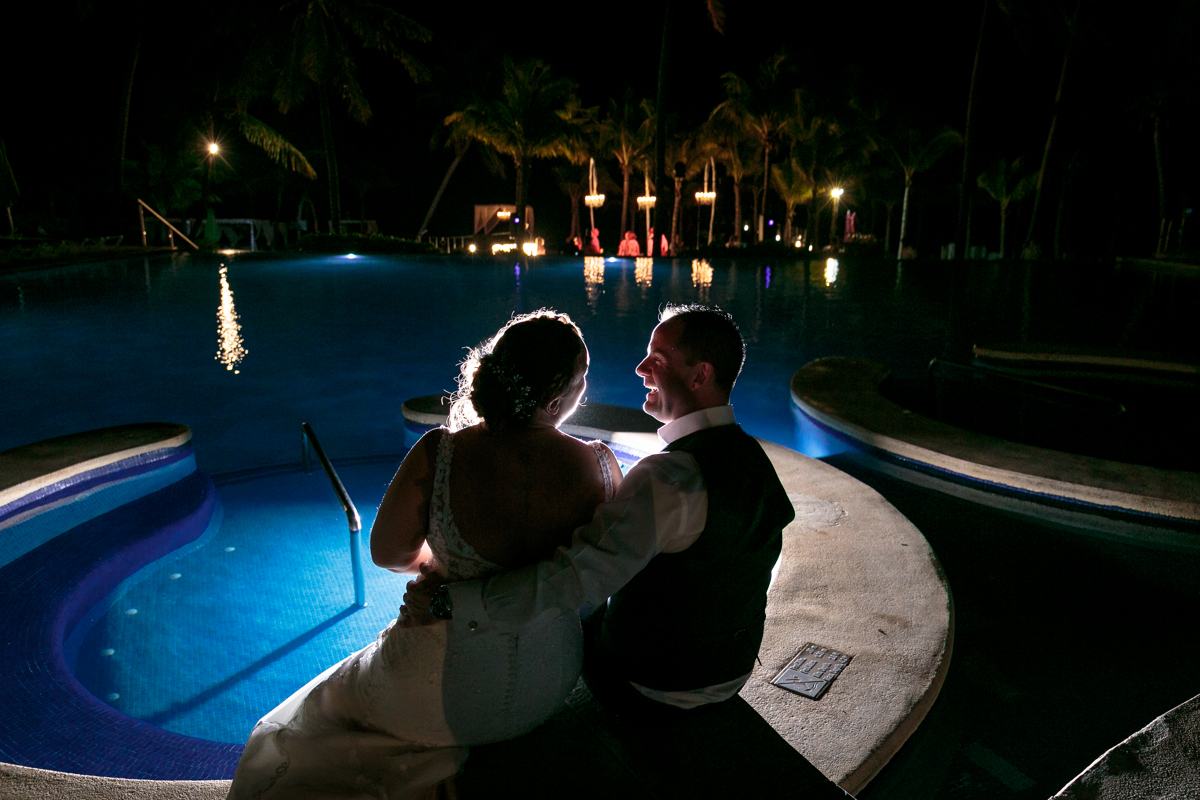 NewlywedsSitBesidePool