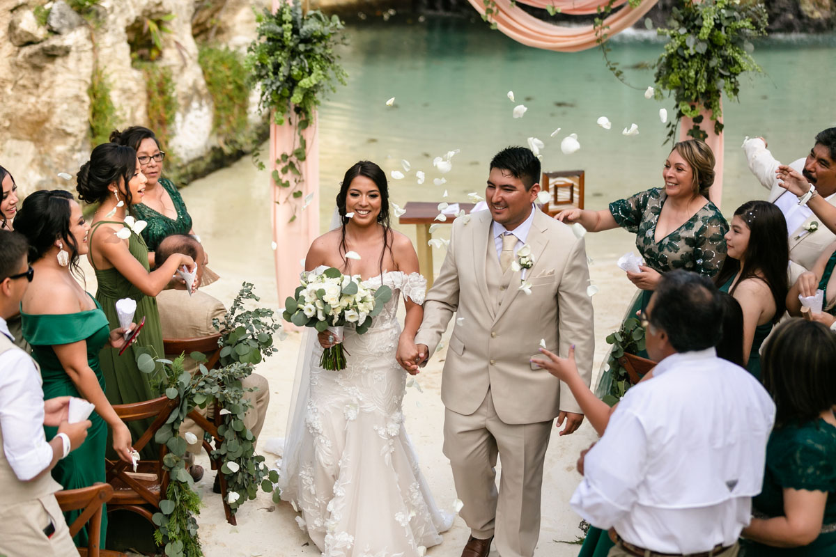 Newlyweds exit ceremony under a shower of petals