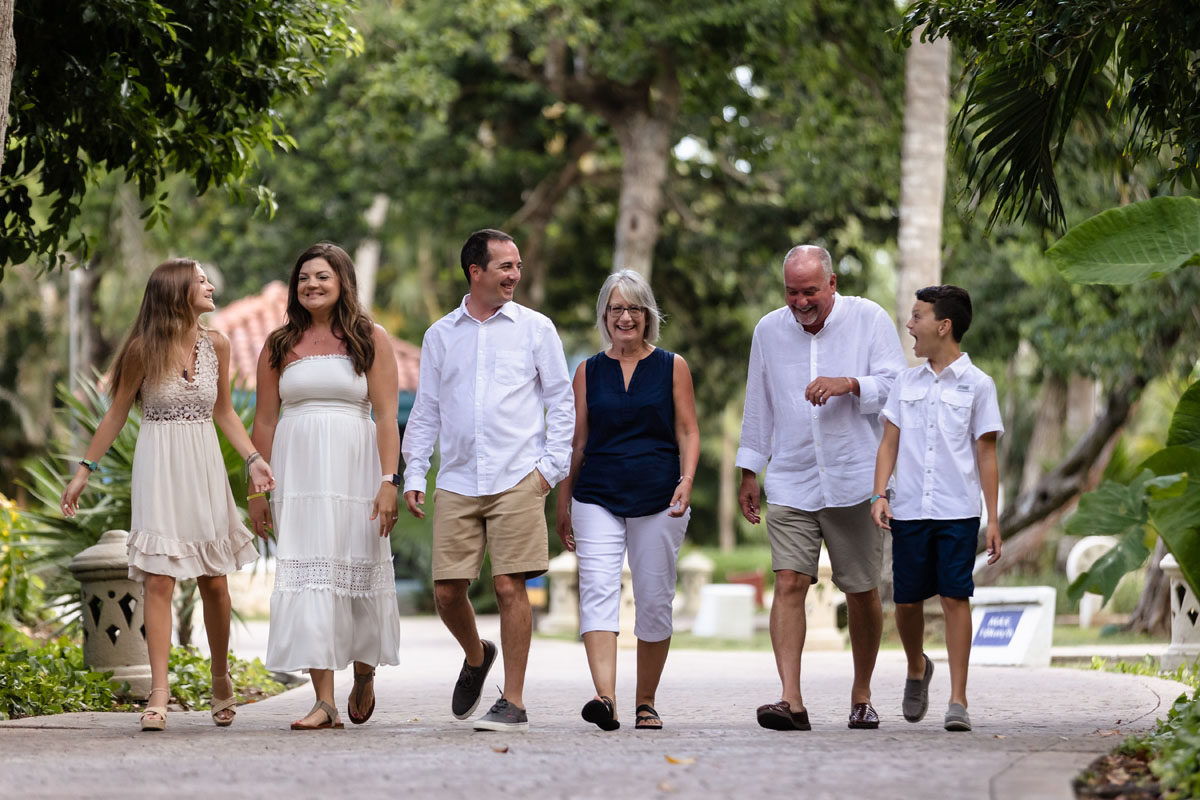 Happy family strolls on jungle path laughing together