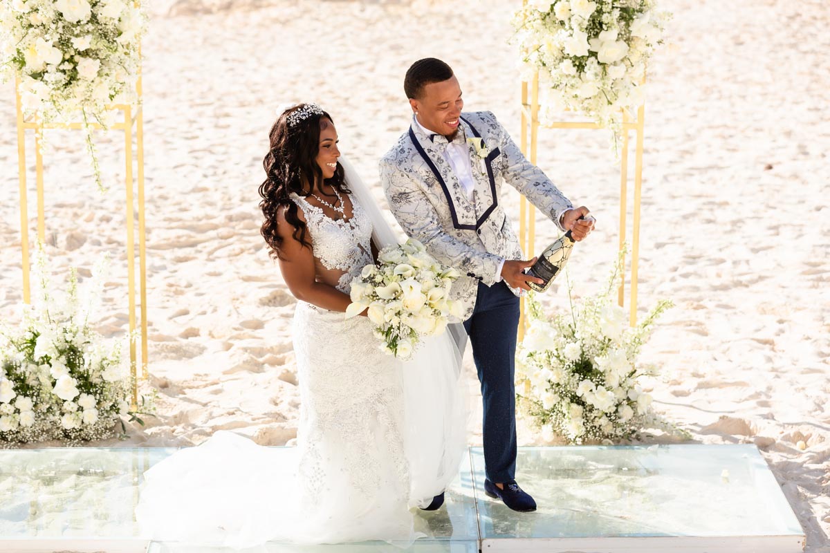 Newlyweds pop a champagne cork in celebration