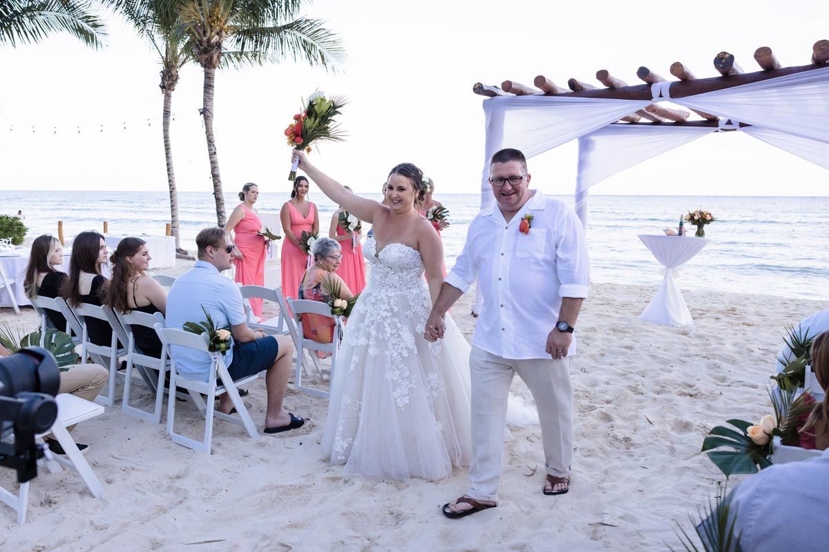 Newlyweds cheer walking out of their ceremony