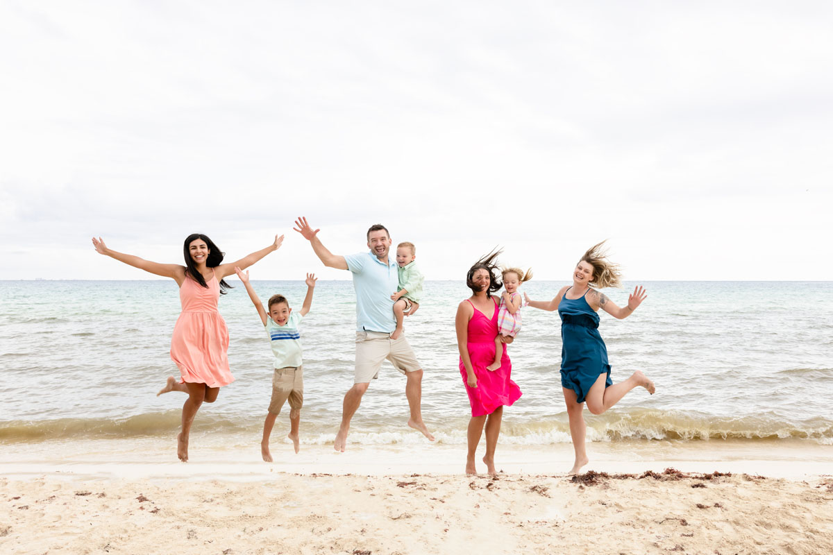 Family jumping for joy together on the beach