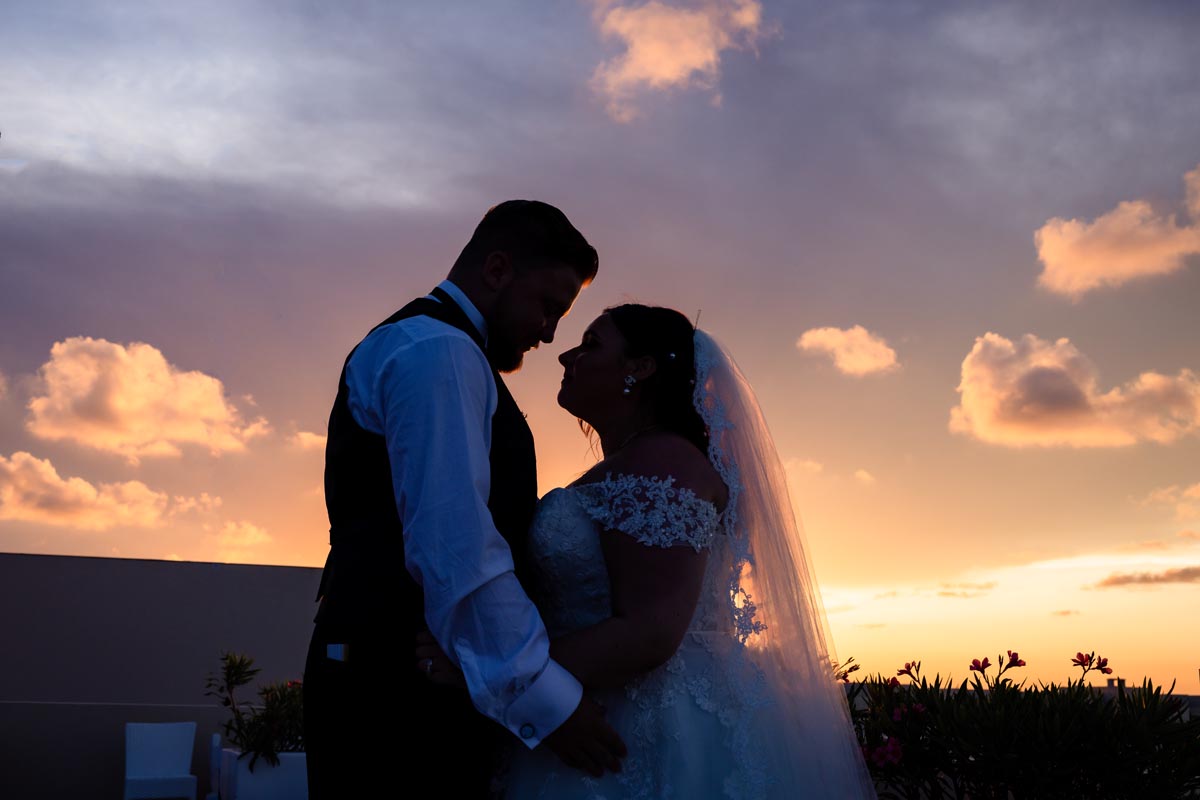 Sunset shilouette of newlyweds embracing