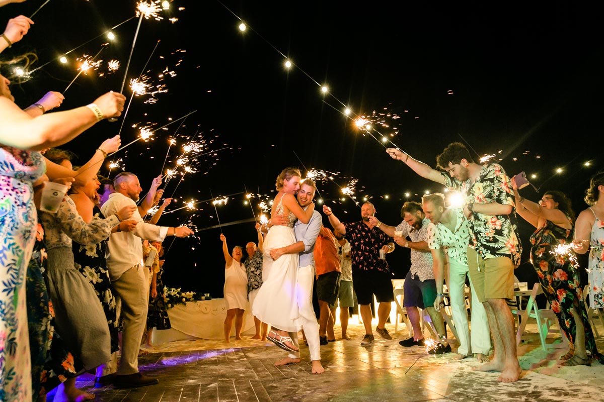 Newlyweds kiss in sparkler gauntlet