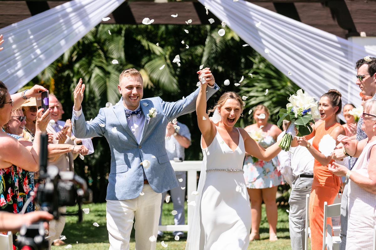 CheeringNewlywedsWalkOutInPetalShower