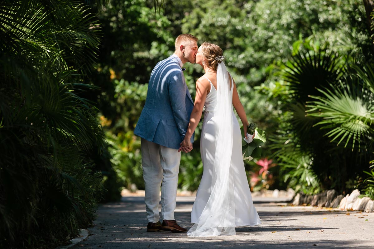 NewlywedsOnGardenPathKissing
