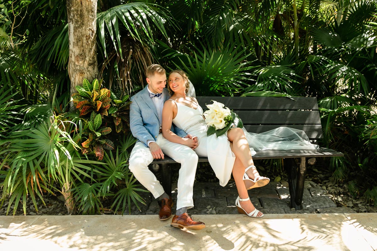 NewlywedsPoseOnGardenBench