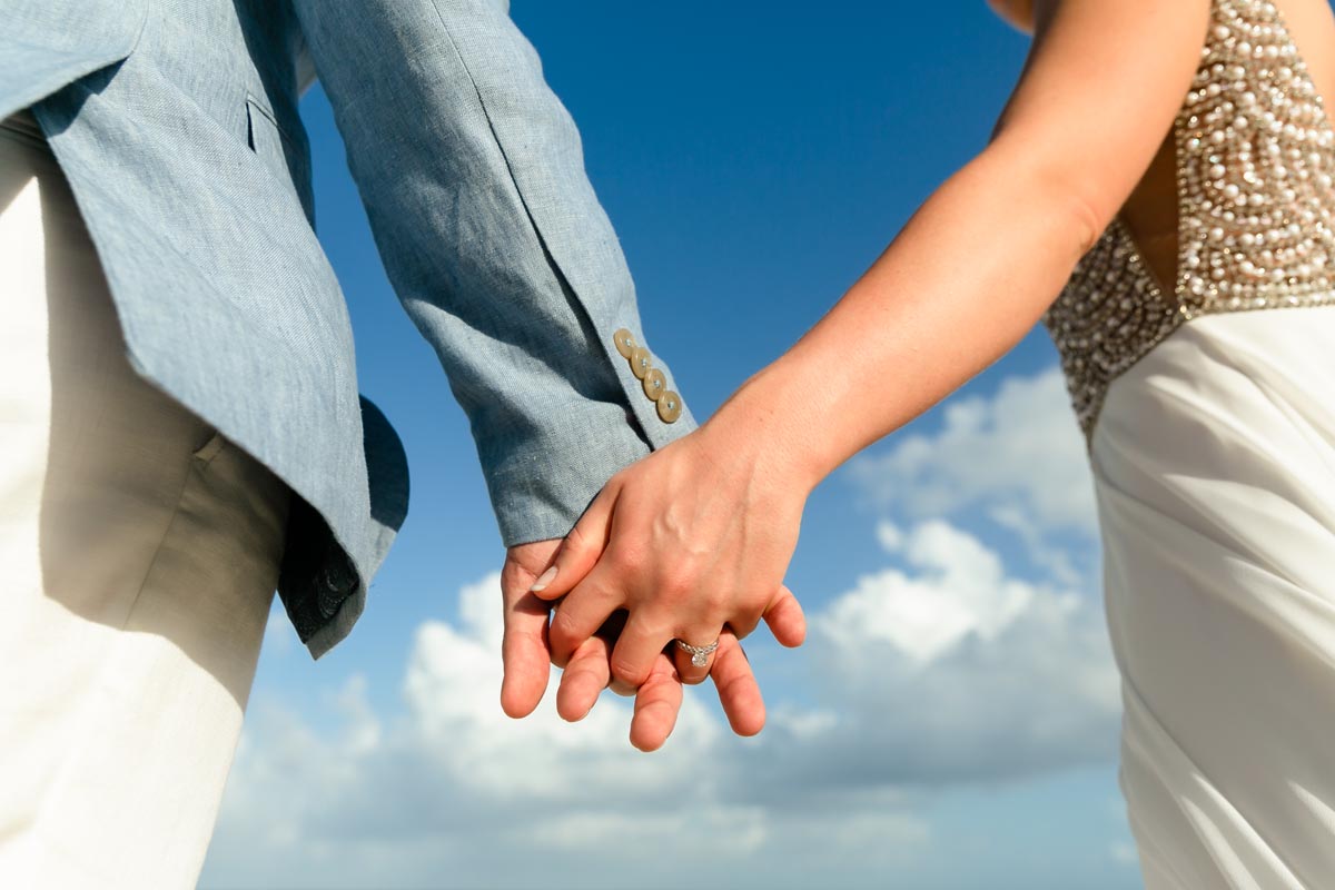 SandosPlayacarNewlywedsHoldHandsShowingRing