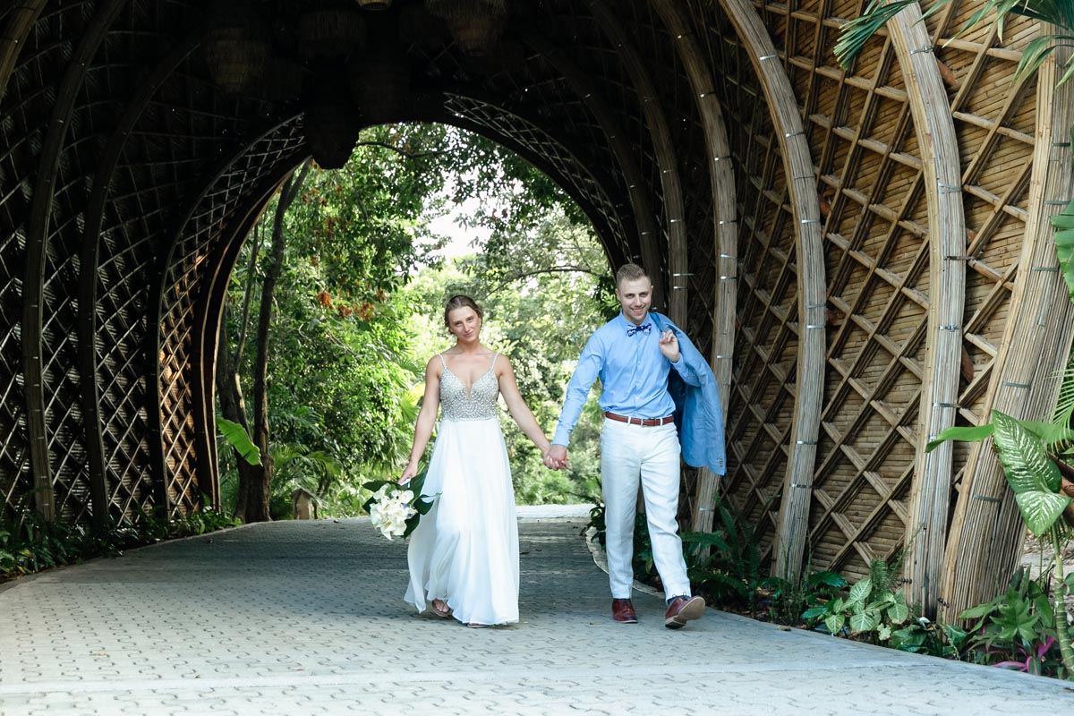 NewlywedsWalkUnderReedTunnel