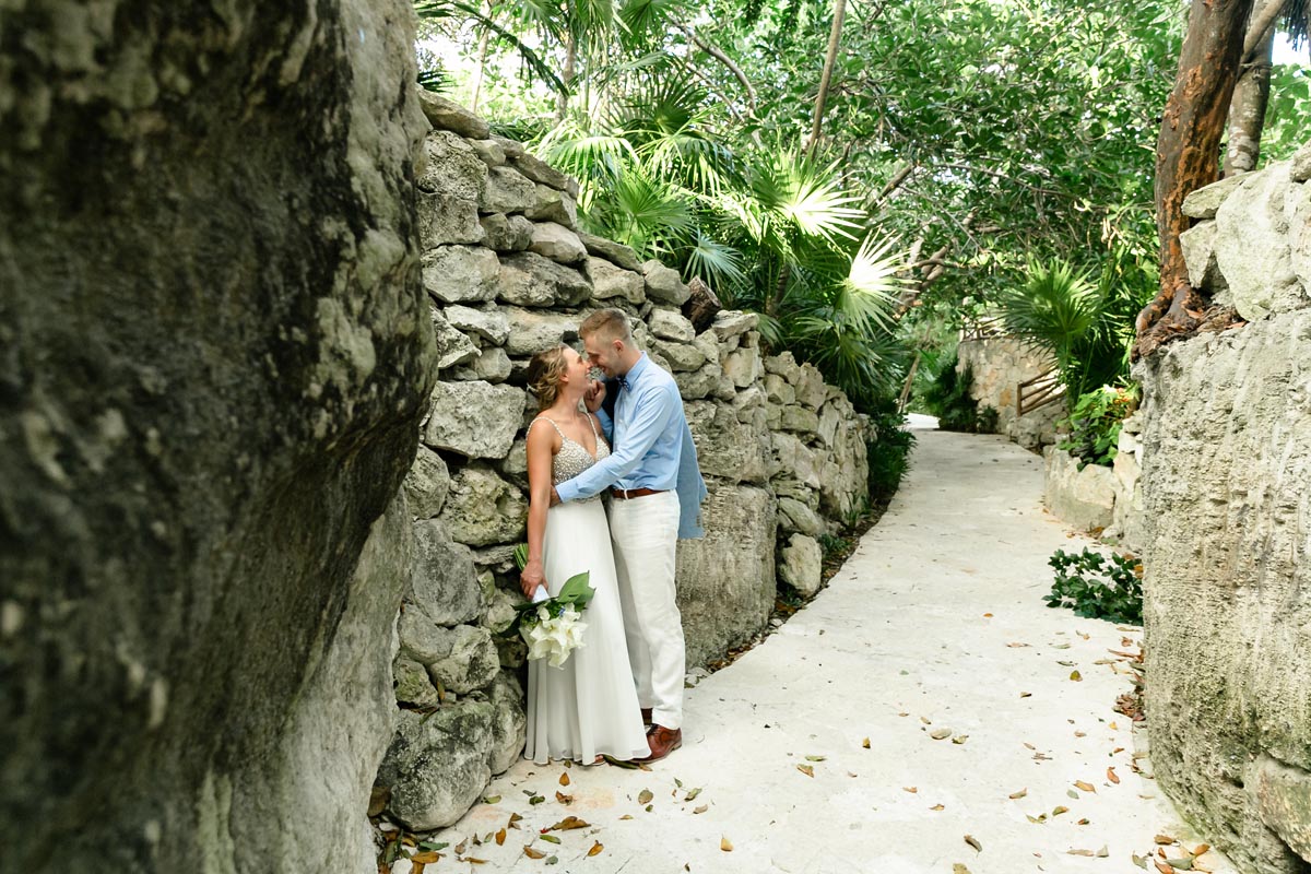 NewlywedsEmbraceByStoneWall