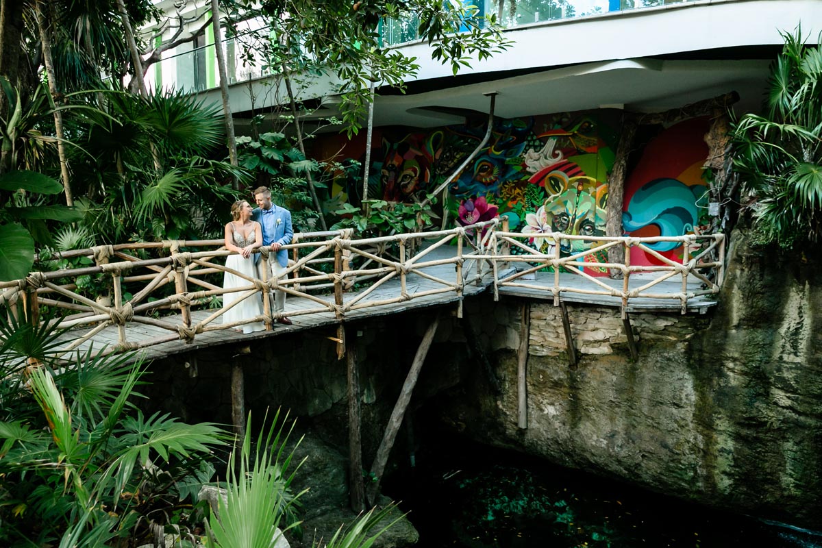 NewlywedsPoseOnWoodenBridge