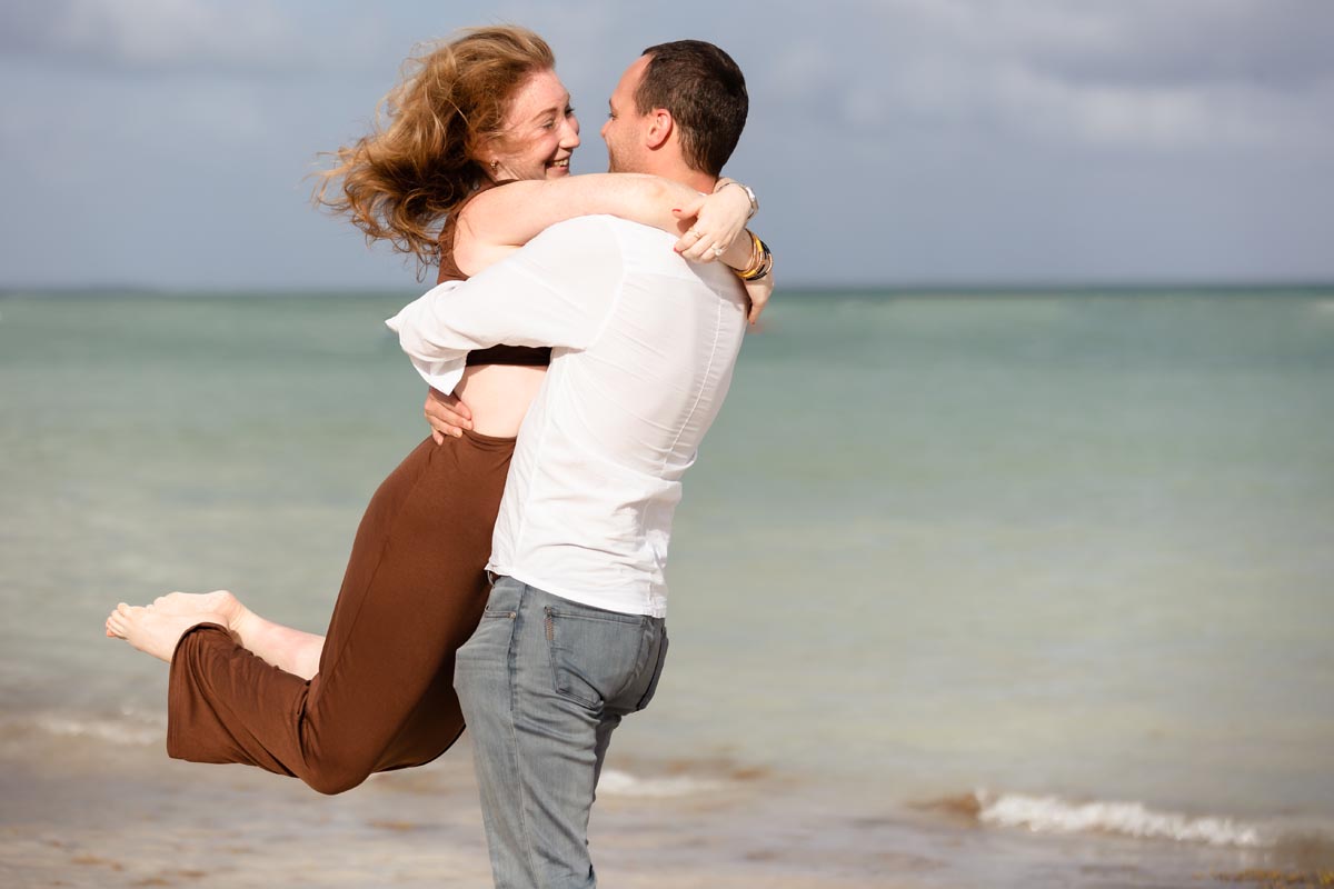 Newly engaged fiancee jumps into her fiance's arms in happiness