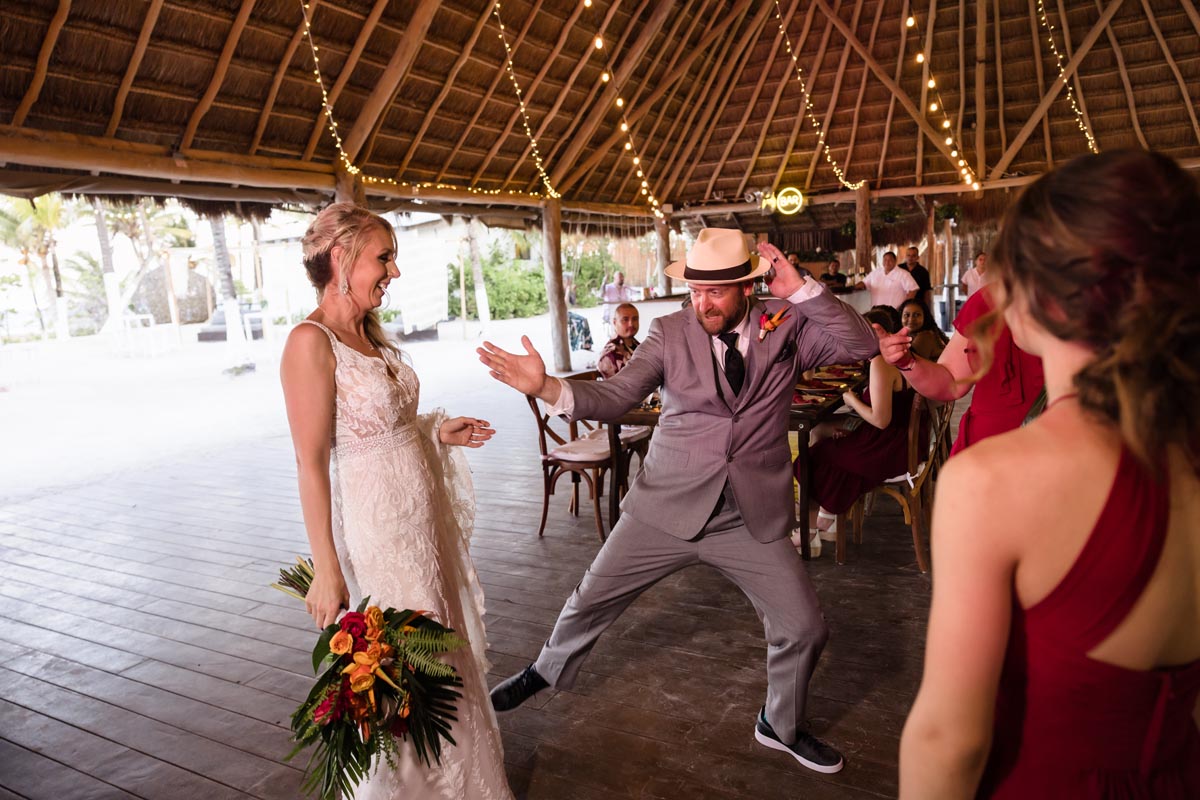 Groom pulls a rocking dance move at the newlyweds reception arrival