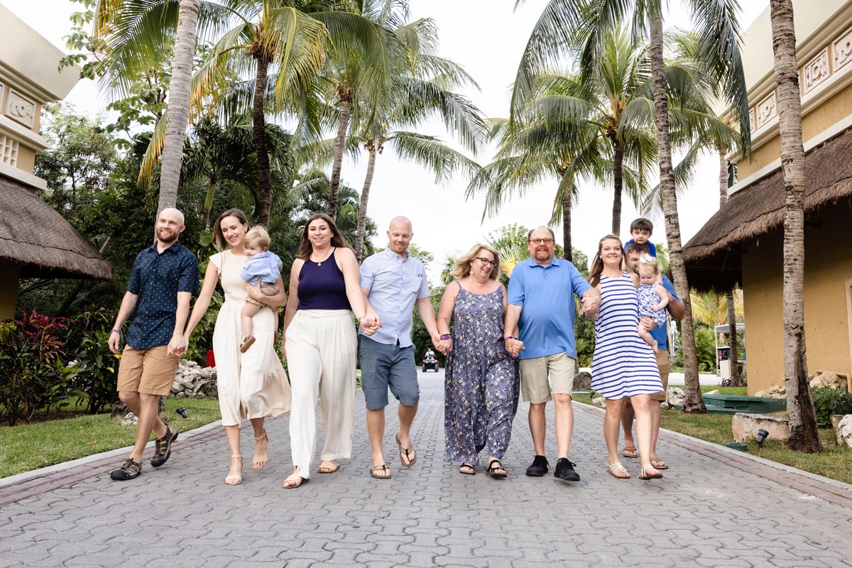 Happy family strolls along a resort street laughing