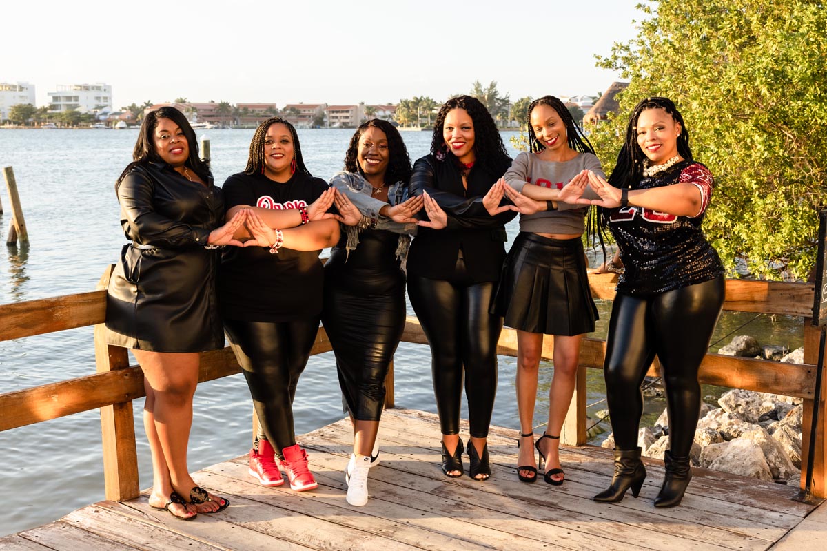 Sorority sisters link arms and form hearts with each others hands