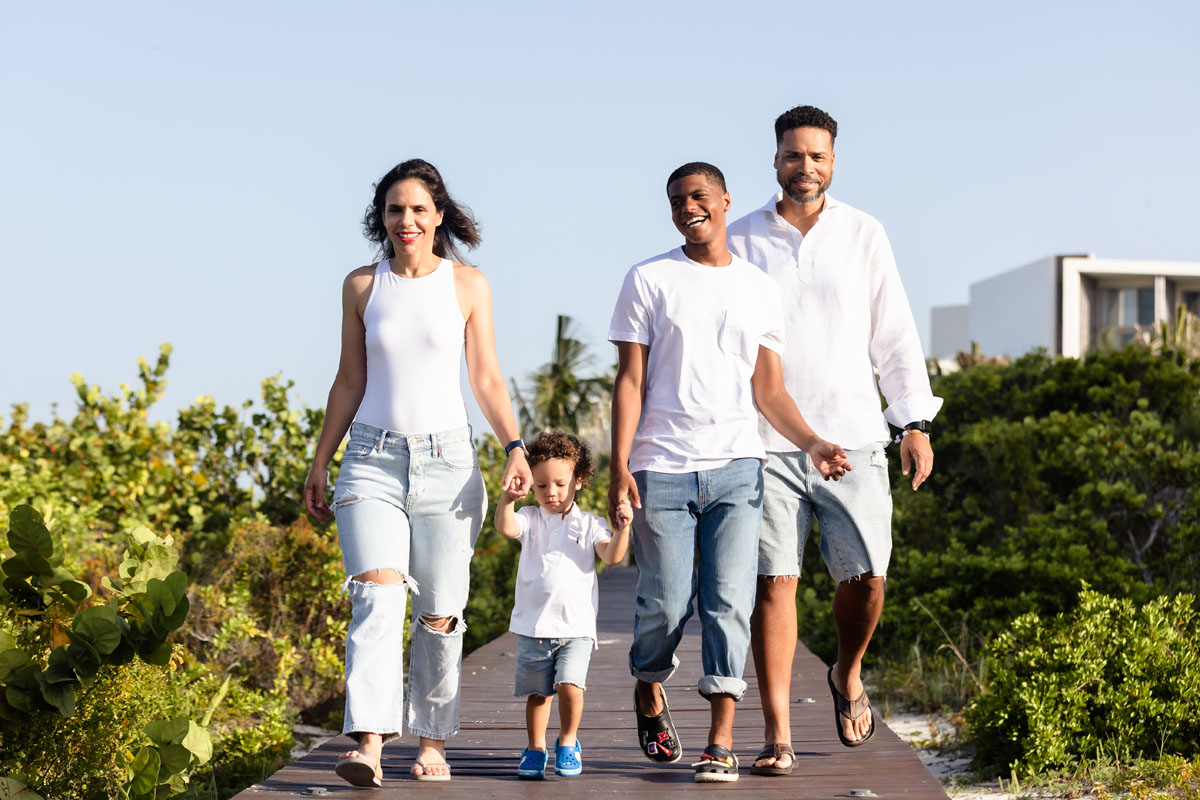 Happy family stroll boardwalk together