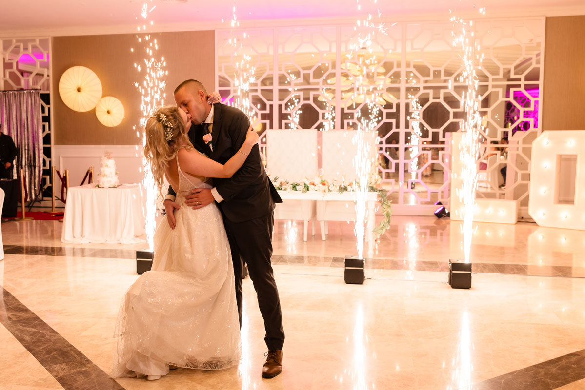 Newlyweds kiss on the dancefloor in a spray of shooting sparklers