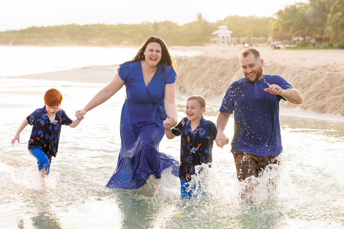 Molly's family laugh happily, running in the shallows, splashing