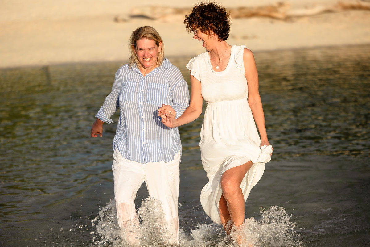 Catherine and Tara splash through the shallows laughing