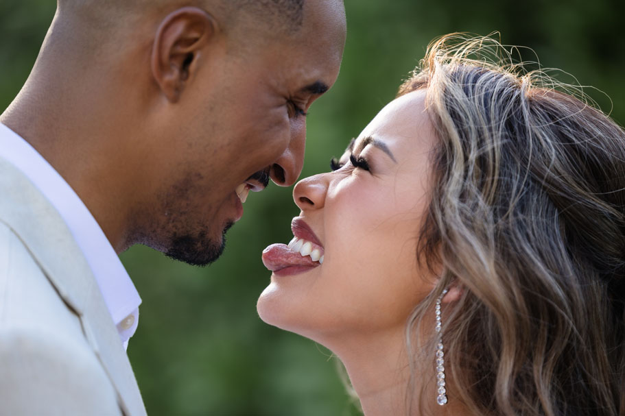 Playful bride sticks out her tongue at her groom