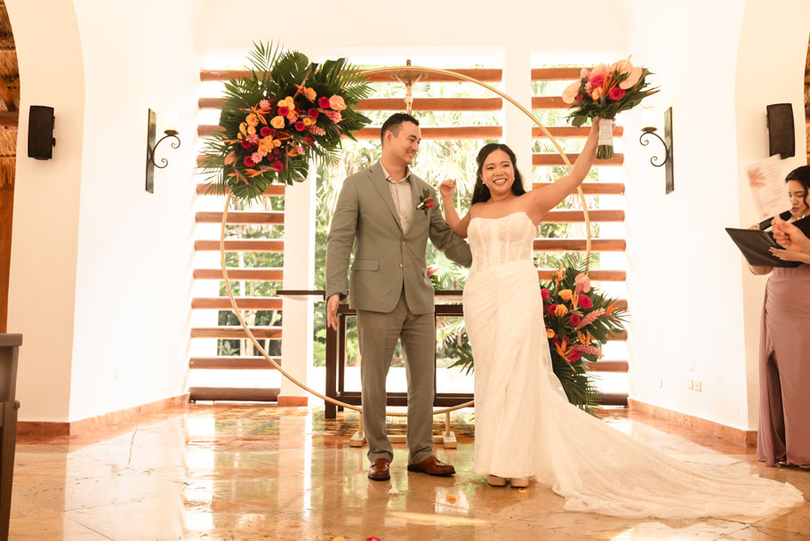 Newlyweds cheer after their ceremony in the chapel